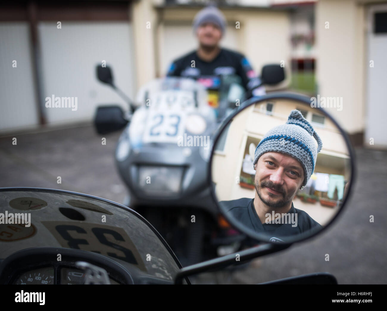 Motorrad-Freunde, Andreas Fuertig (l) und Roman Bekkaoui (r) auf ihre Fahrräder im Hof eines Hauses im Stadtteil Gallus in Frankfurt/Main, Deutschland, 7. Oktober 2016 sitzen. Sie tragen Hüte in Form von Apfel Wein Krüge, auch bekannt als "Bembel". Das Hessische Duo "Baltic Sea Circle 2016" Rallye teilgenommen und 8.000 Kilometer rund um die Ostsee absolviert. Foto: FRANK RUMPENHORST/dpa Stockfoto