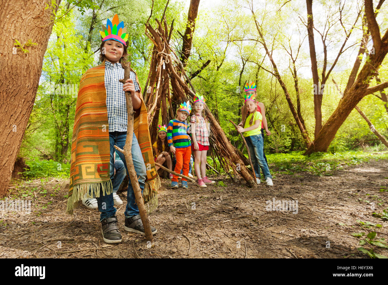 Süsser Boy spielen Indianerhäuptling in den Wald Stockfoto