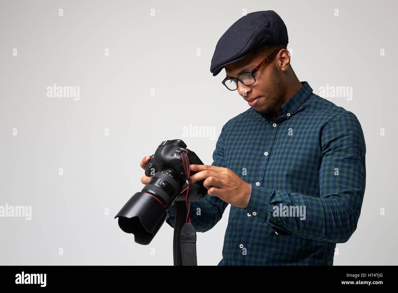 Studio-Porträt des männlichen Fotografen mit Kamera Stockfoto