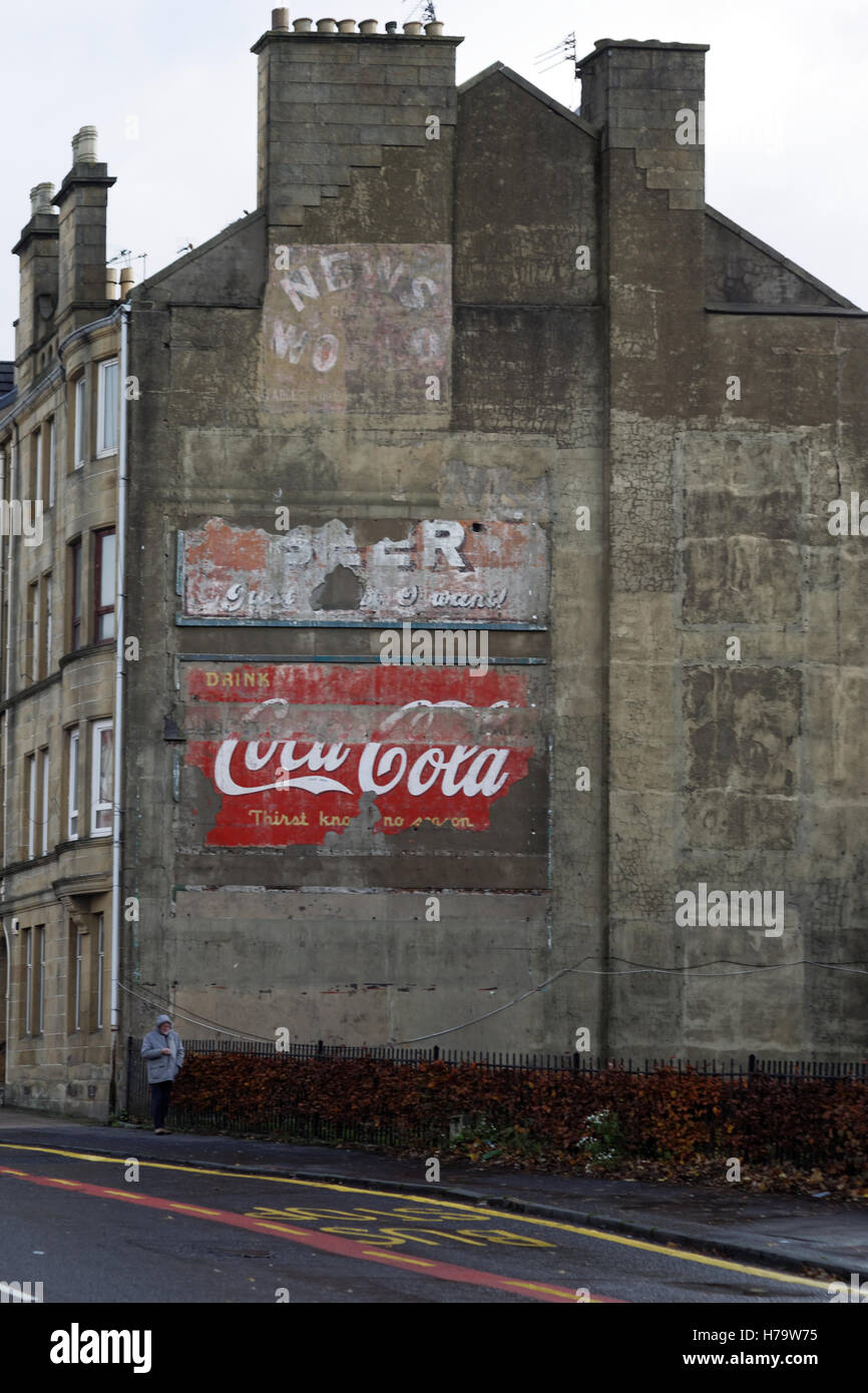 Alte Vintage-Werbeschilder auf der Seite des Mietshauses Koks Coca Cola Nachrichten der Welt und Bier Stockfoto