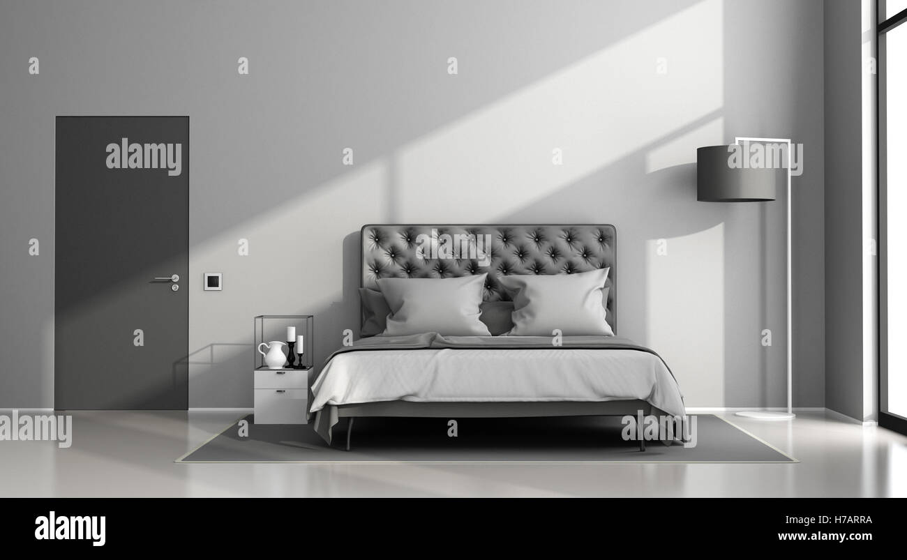 Schwarze und graue Hauptschlafzimmer mit eleganten Doppelbett und geschlossener Tür - 3d rendering Stockfoto