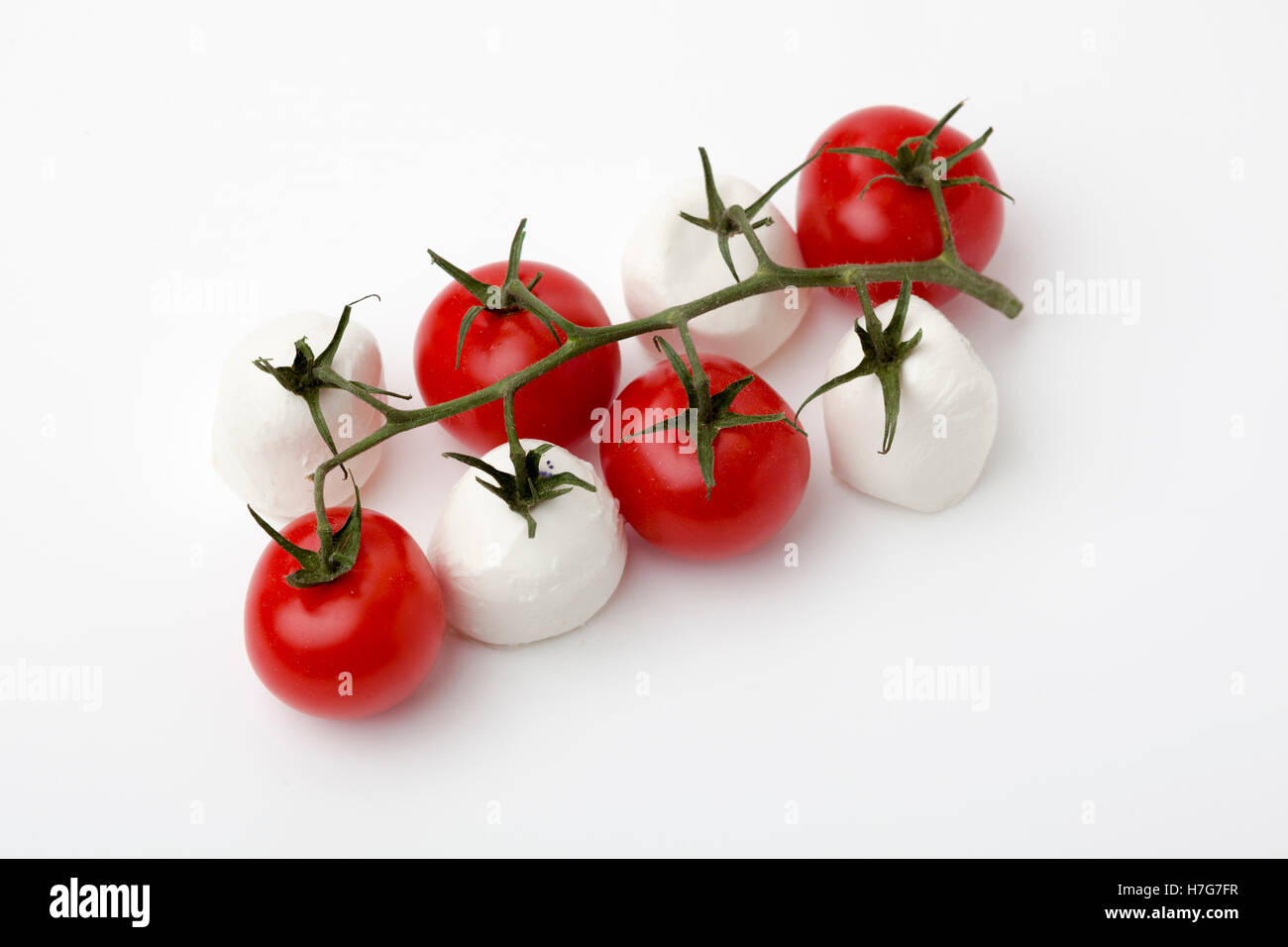 Mozzarella und Tomaten auf Rebe Stockfoto