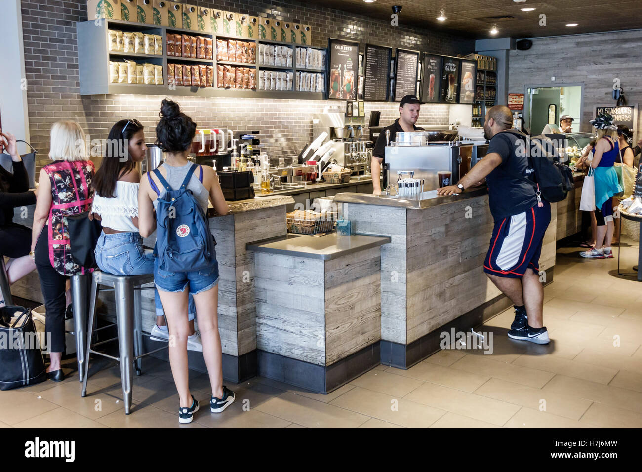 New York City, New York NYC Manhattan, Upper East Side, Starbucks Coffee, Gäste, Theke, Erwachsene, Männer, Männer, Frauen, Barista, Kassierer, junge Gäste Stockfoto