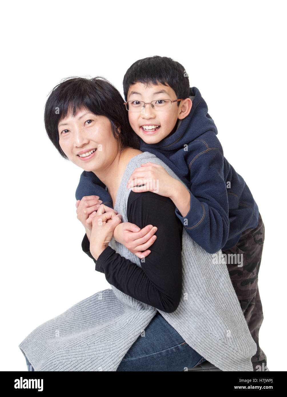 Liebevolle kleine asiatische junge und seine Mutter in einer glücklich Pose. Isoliert auf weißem Hintergrund. Stockfoto