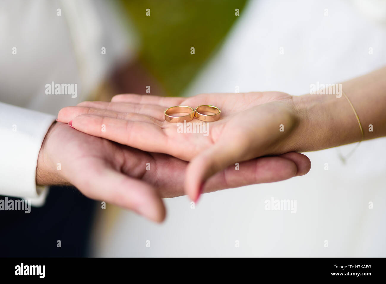Nahaufnahme von Brode und des Bräutigams Hand hält zwei Trauringe Stockfoto