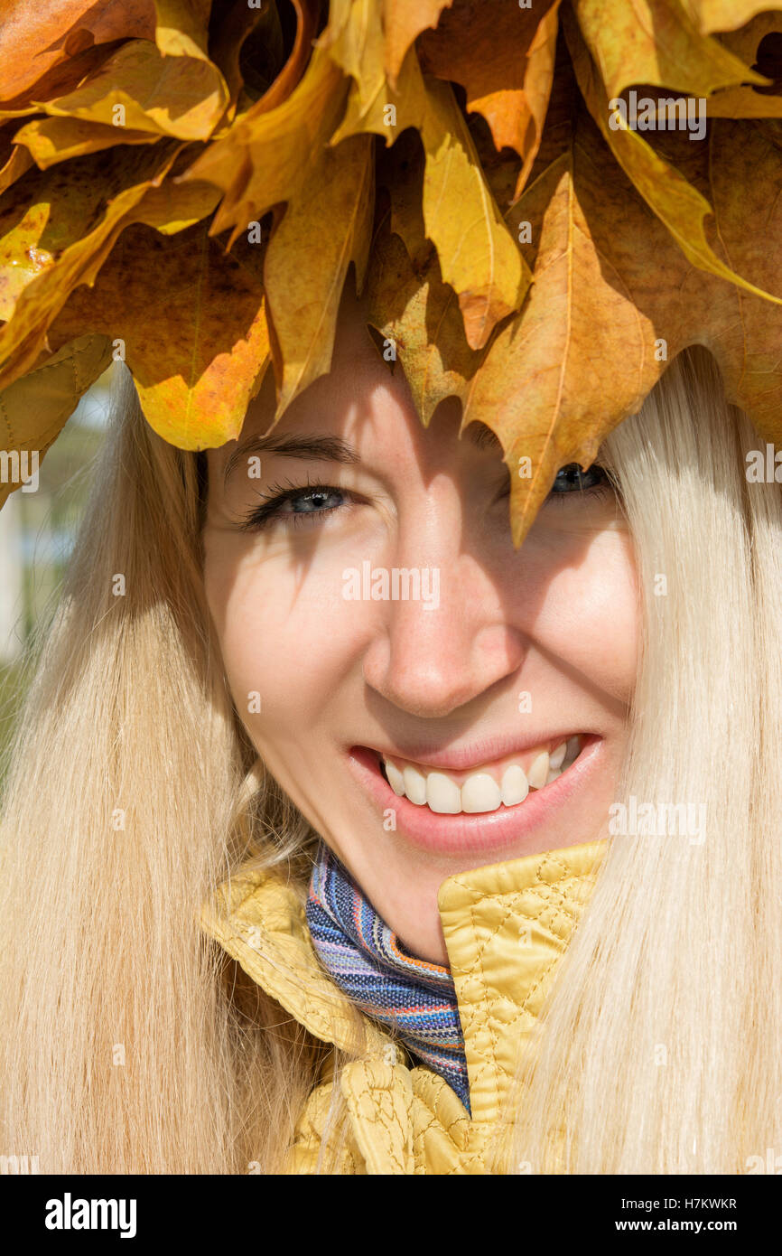 junges Mädchen mit Herbstlaub Stockfoto