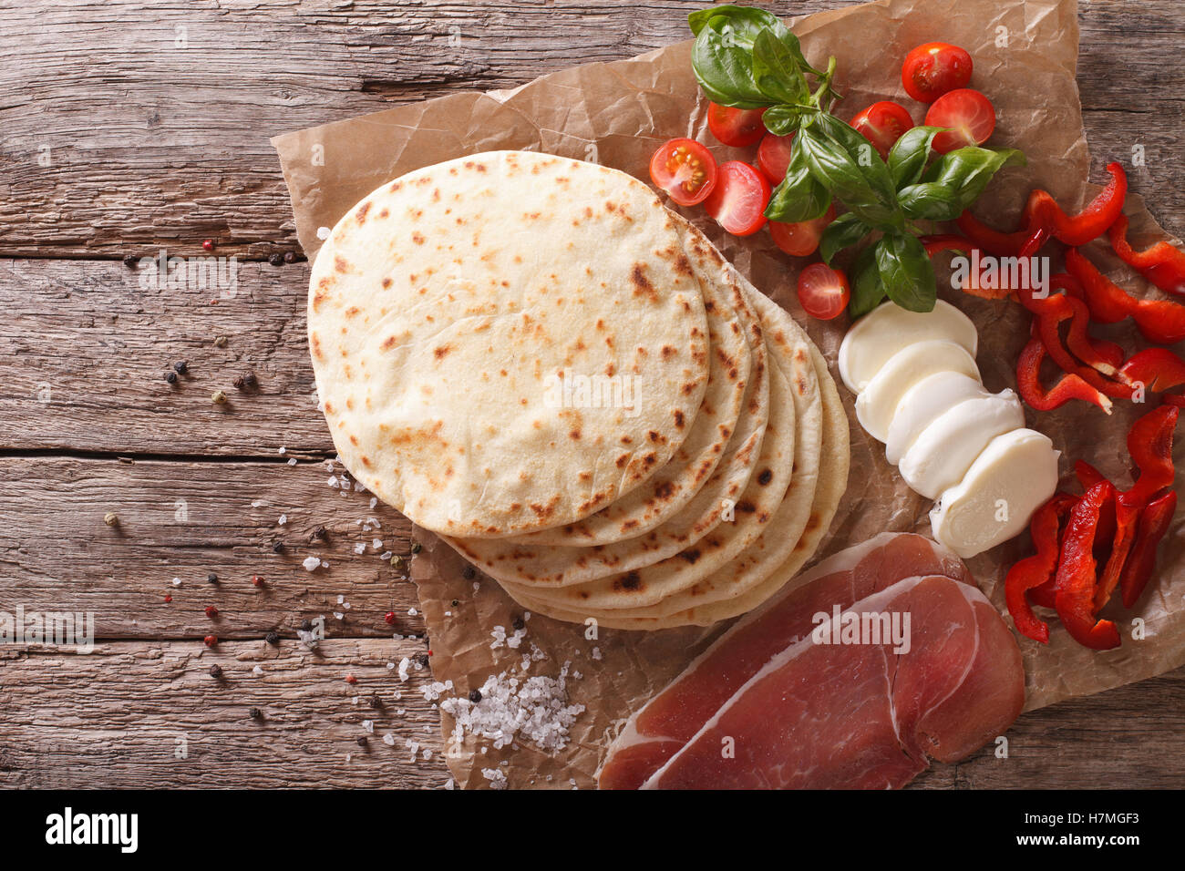 Italienische Piadina flaches Brot, Schinken, Käse und Gemüse close-up auf dem Tisch. horizontale Ansicht von oben Stockfoto