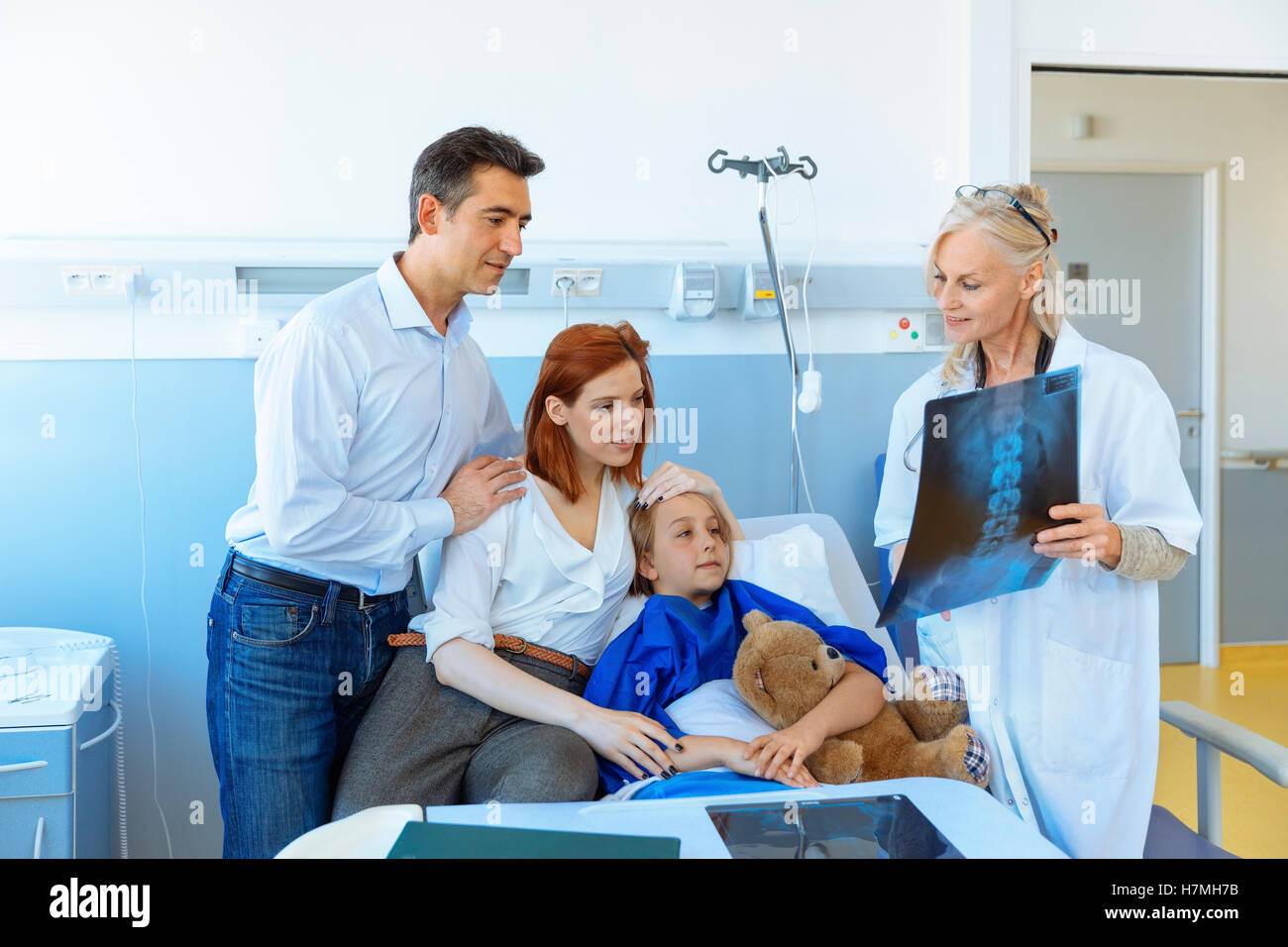 Kinderarzt besuchen Eltern und Kind im Krankenhausbett Stockfoto