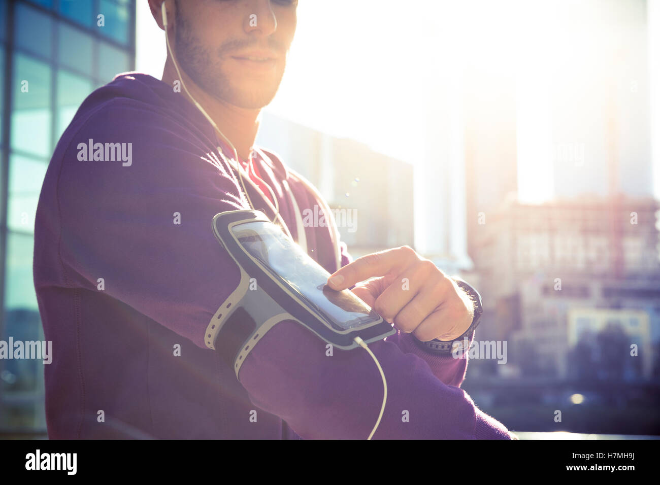 Laufende Training Mann Musikhören mit MP3-Player Armband oder Mobile Smartphone. Stockfoto