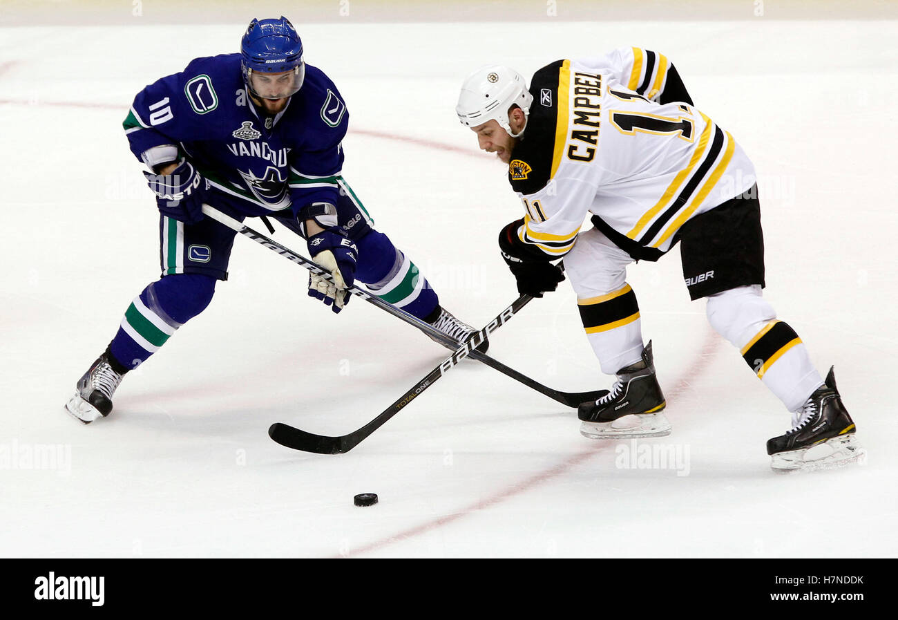 15. Juni 2011; Vancouver, BC, Kanada; Vancouver Canucks linken Flügel, die Jeff Tambellini (10) Schlachten um den Puck mit Boston Bruins Gregory Campbell (11) in der ersten Periode der Mitte Spiel sieben von 2011 Stanley Cup-Finale in der Rogers Arena. Stockfoto