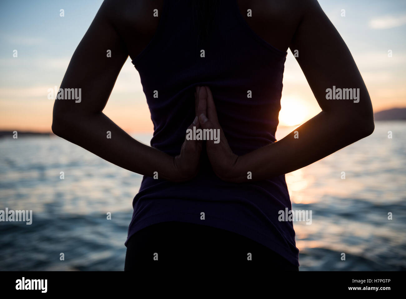 Mittleren Bereich der Frau, die Durchführung von Yoga am Strand Stockfoto