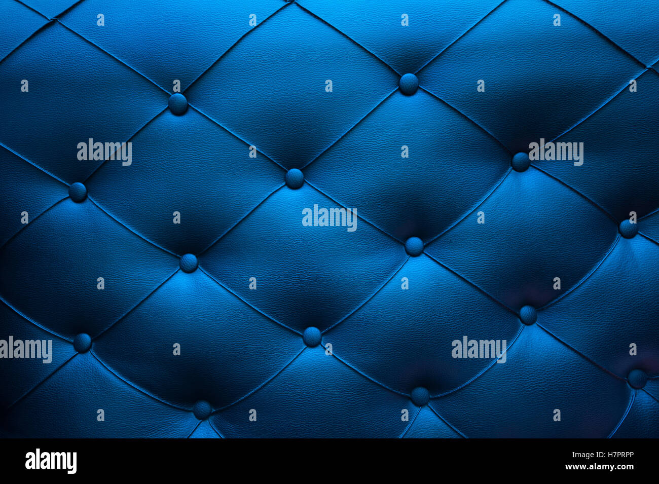 Blaue Leder-Textur auf dem Sofa mit Knöpfen Stockfoto