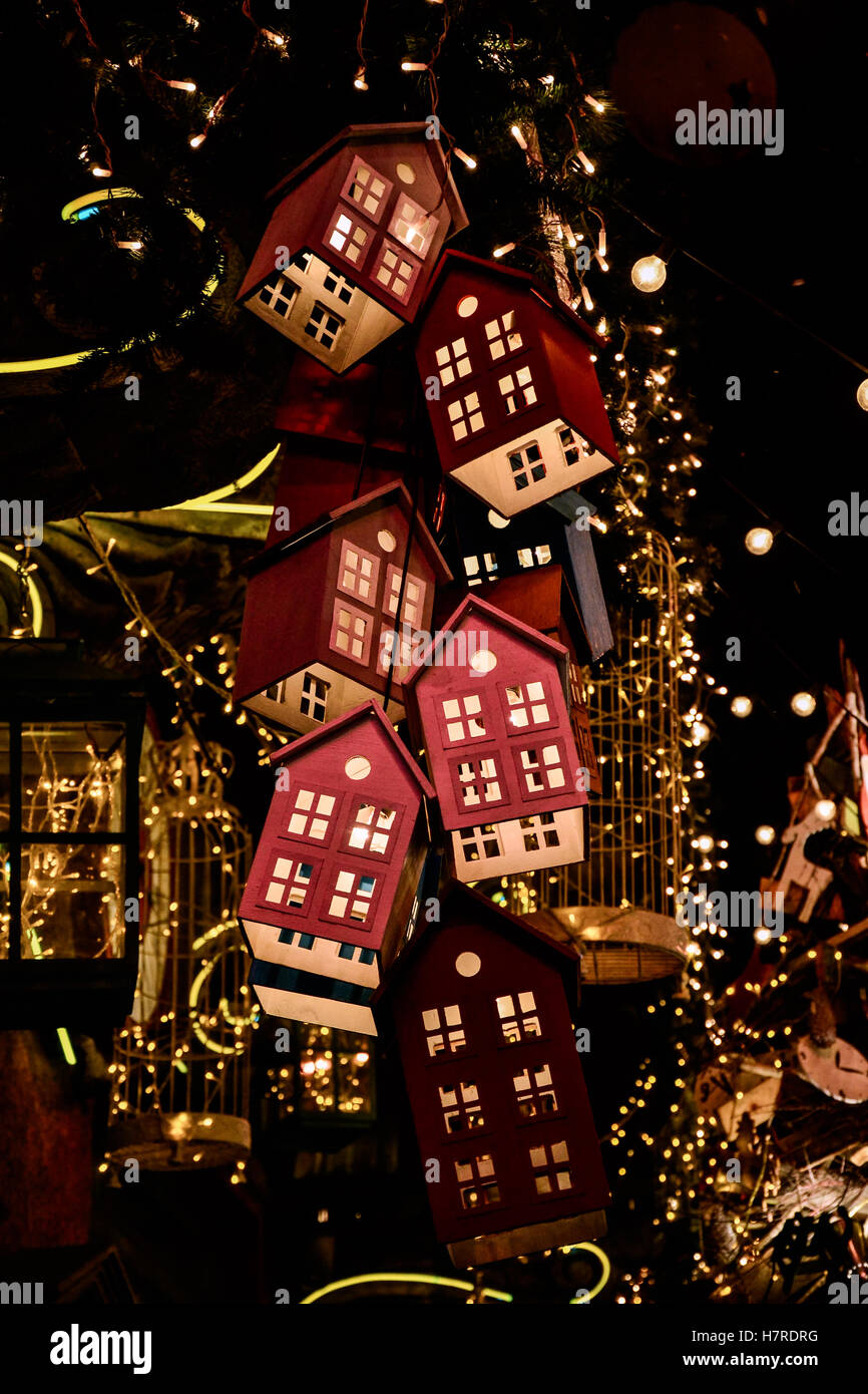 Leuchtende Spielzeug Häuser am Weihnachtsbaum im Dunkeln Stockfoto