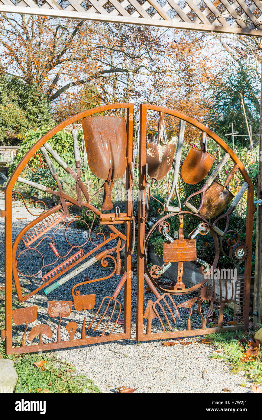 Gemeinschaft Gartentor hergestellt aus verrosteten Gartenwerkzeuge Stockfoto