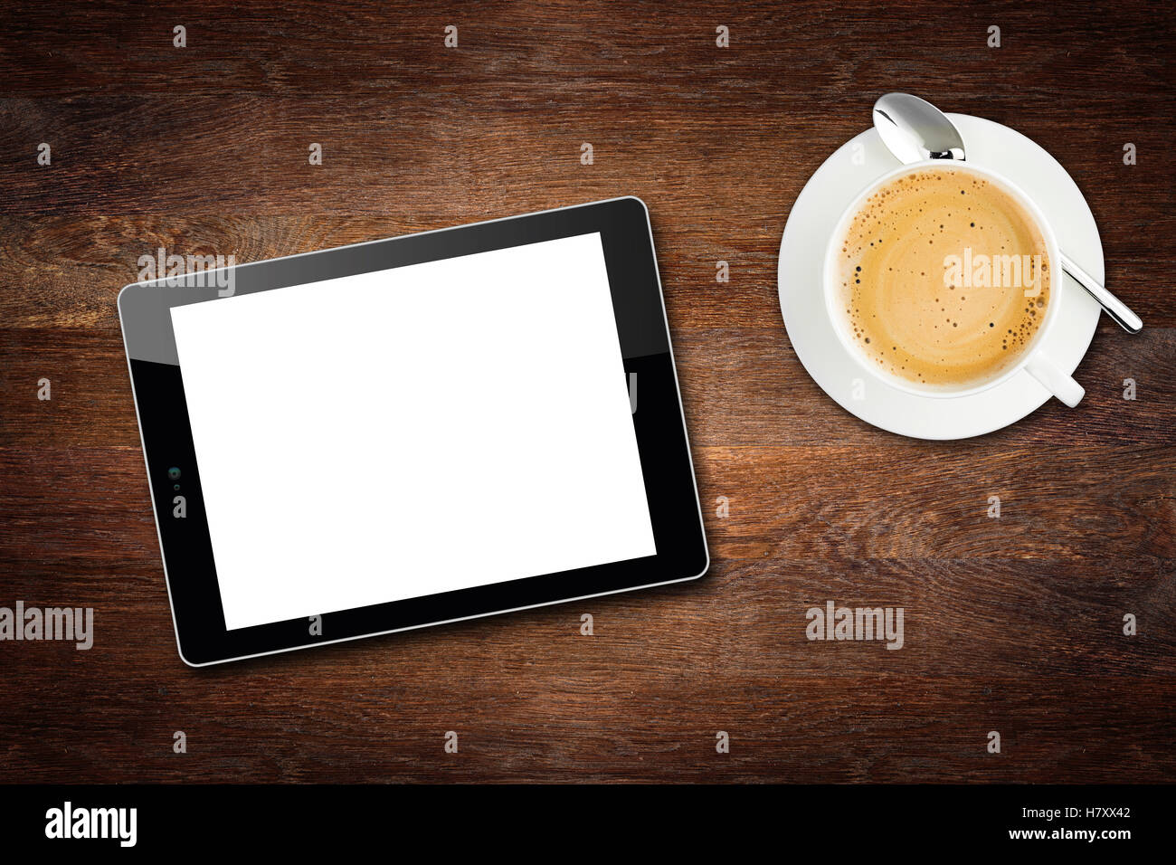 hölzerne Tischplatte Desktopansicht Pause Konzept mit Tablet und Kaffee Tasse Stockfoto