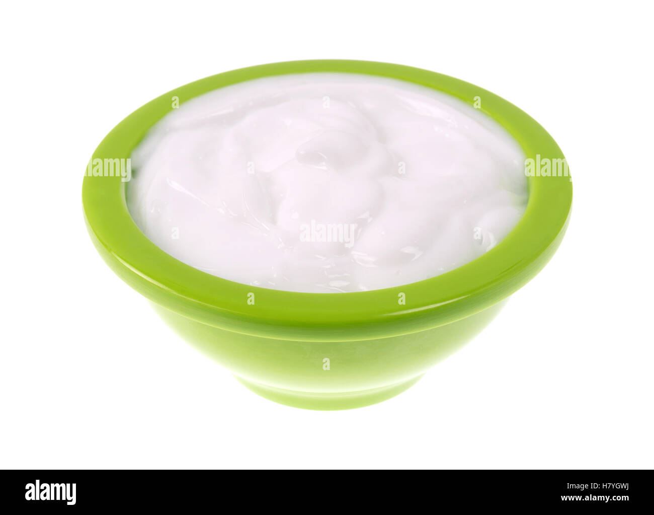 Eine kleine grüne Schale mit Vitamin E Lotion isoliert auf einem weißen Hintergrund. Stockfoto