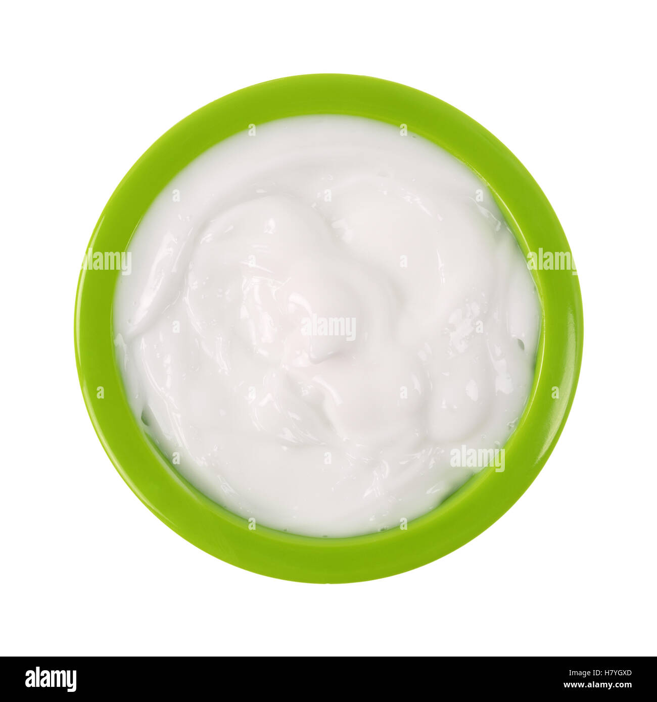 Draufsicht auf eine kleine grüne Schüssel gefüllt mit Vitamin E Lotion isoliert auf einem weißen Hintergrund. Stockfoto