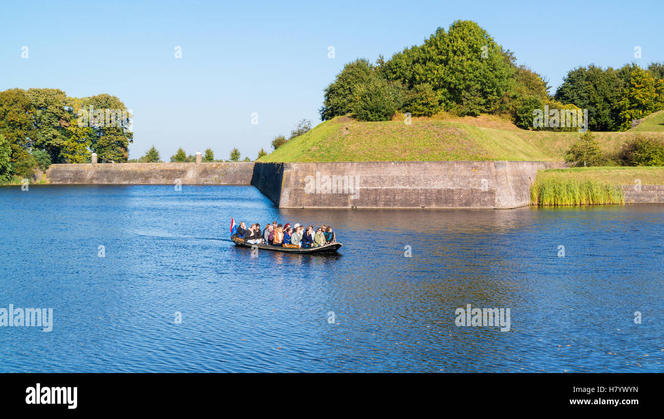 Menschen in Touristenboot auf Graben und Bastion Oud Molen in befestigte Stadt Naarden, Nordholland, Niederlande Stockfoto