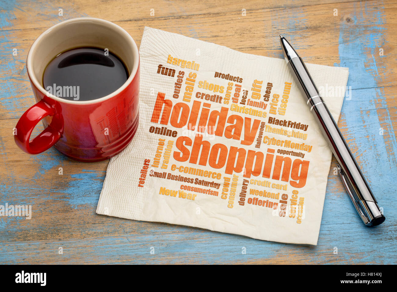 Weihnachtseinkäufe Wortwolke auf einer Serviette mit einer Tasse Kaffee Stockfoto