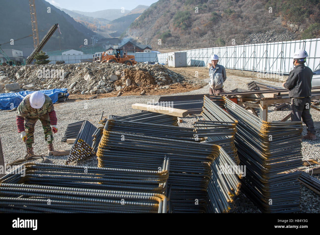 Arbeiter tragen auf den Aufbau der neuen Alpincenter, der Ort, wo die Olympischen alpinen Skirennen und den Super-G, in der Region Pyeongchang, Südkorea, 9. November 2016 durchgeführt werden. Die Olympischen Winterspiele wird vom 9. bis den 25. Februar 2018 im südkoreanischen Pyeongchang Berggebiet und entlang der Küste in Gangneung stattfinden. Foto: Michael Kappeler/dpa Stockfoto