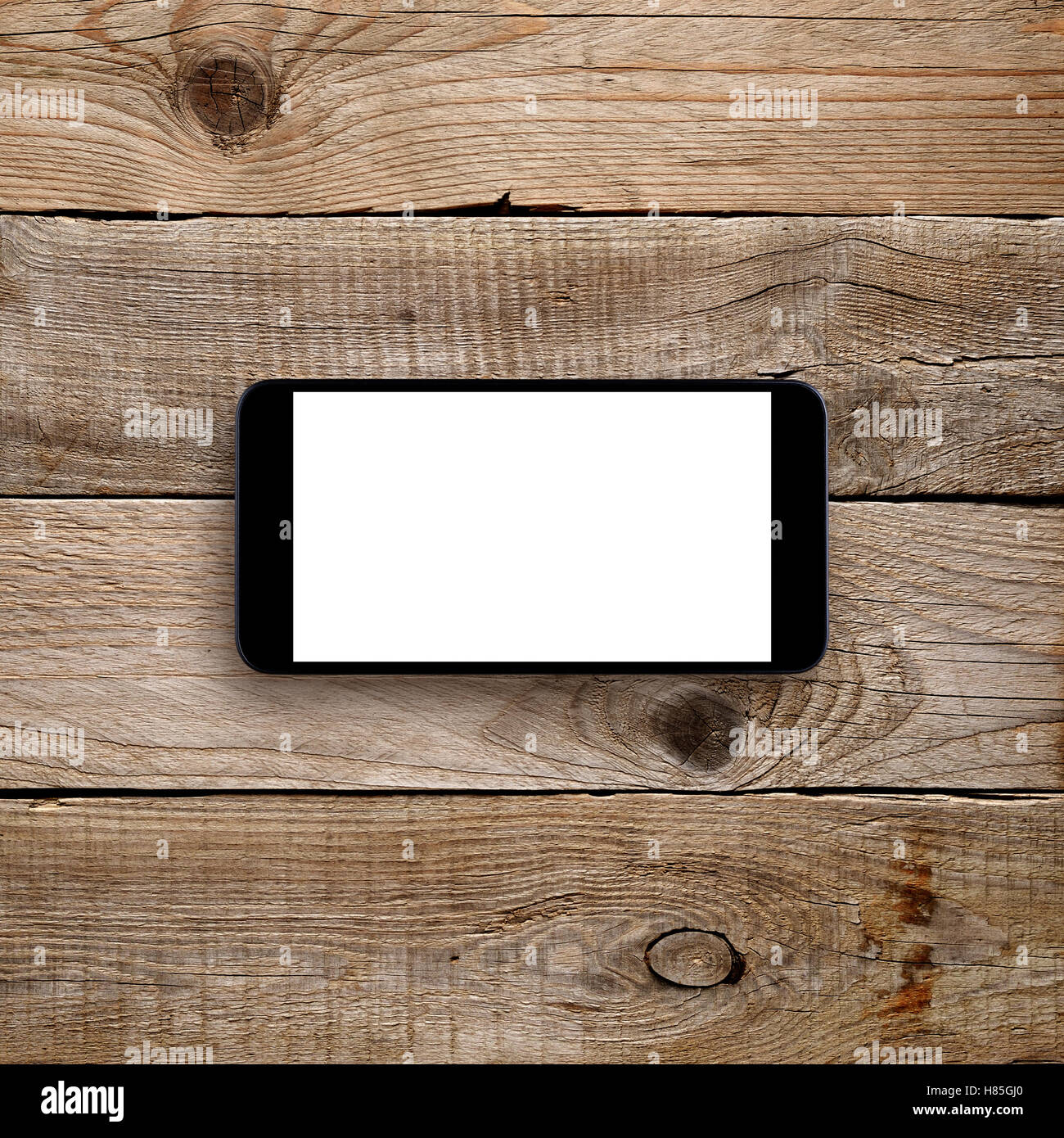 Smartphone mit leeren Bildschirm auf hölzernen Hintergrund. Horizontale Ansicht Stockfoto