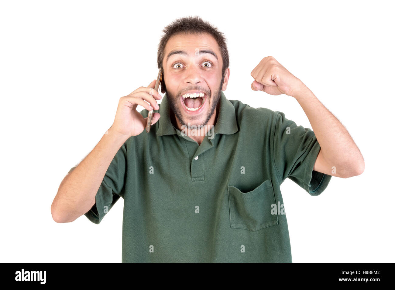 junger Mann mit Handy tun lustige Gesichter isoliert in weiß Stockfoto