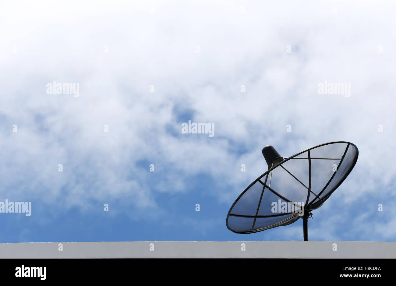 Satellitenschüssel und Wolken am blauen Himmel im Konzept der Kommunikation. Stockfoto