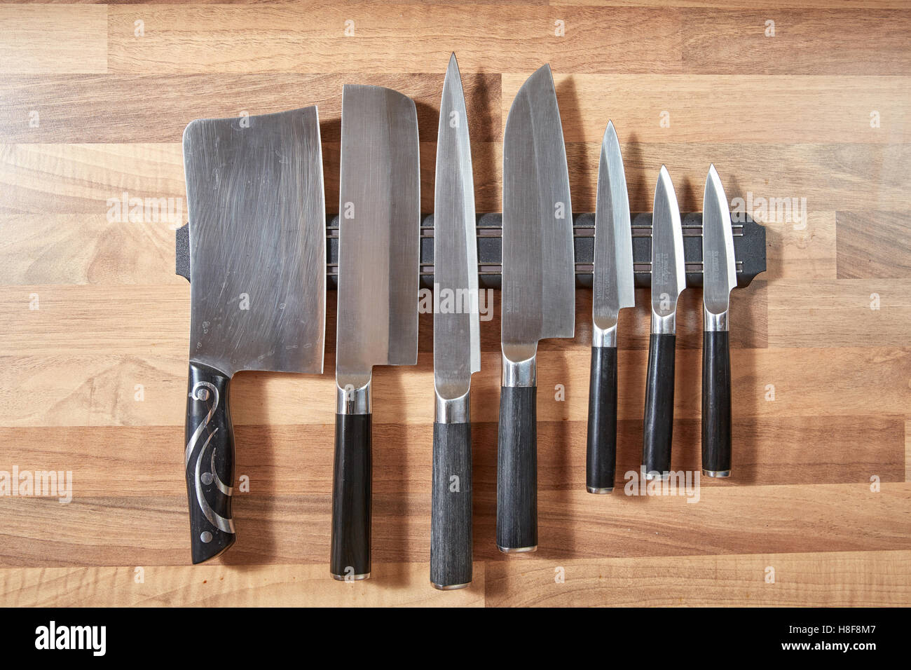 Sieben Küchenmesser Wandmontage braun Eiche Stockfoto