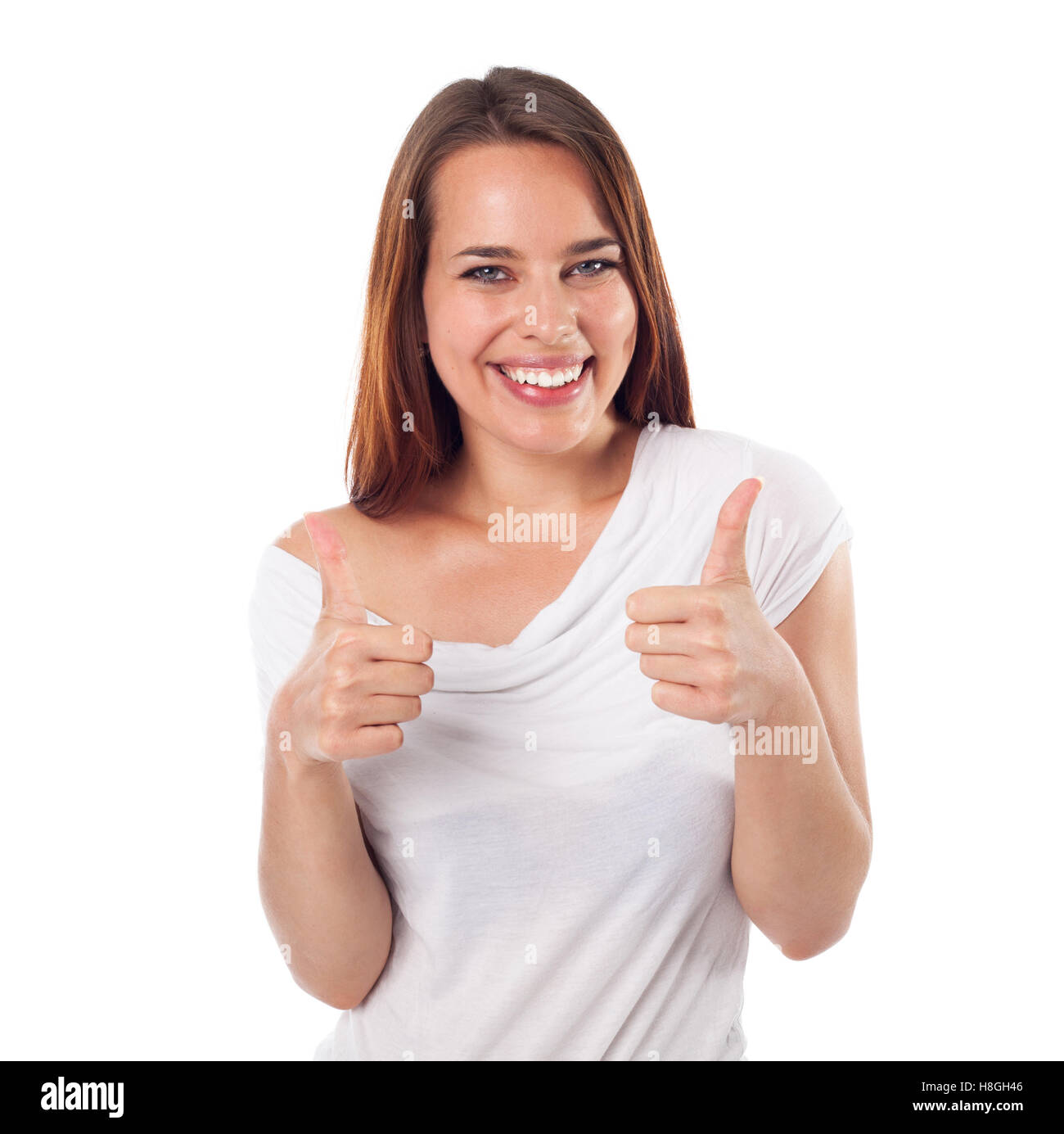 Lächelnde junge Frau mit positive Geste, isoliert auf weiss Stockfoto