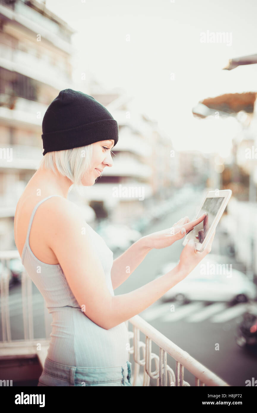 Junge hübsche Mädchen Hipster Stil mit wi-Fi-Tablet-Gerät Denken auf städtischen Hintergrund Stockfoto