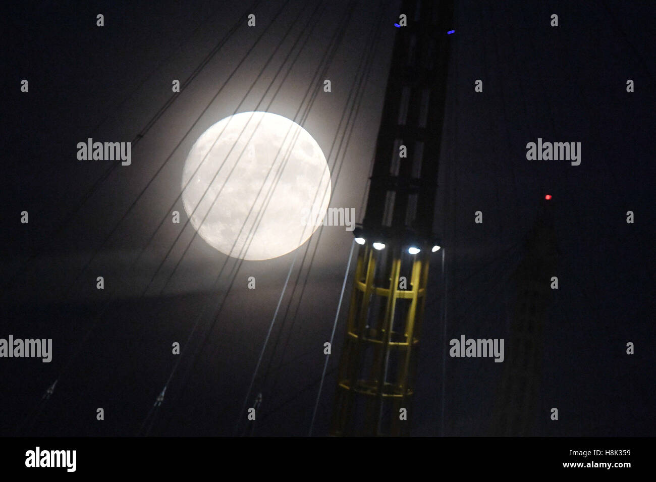 Der Mond über der O2 Arena in Süd-Ost-London, als eine seltene Supermoon machen volle Mondscheibe 14 % größer erscheinen und bis zu 30 % heller als üblich, da es über den Dächern am Montag steigt. Stockfoto