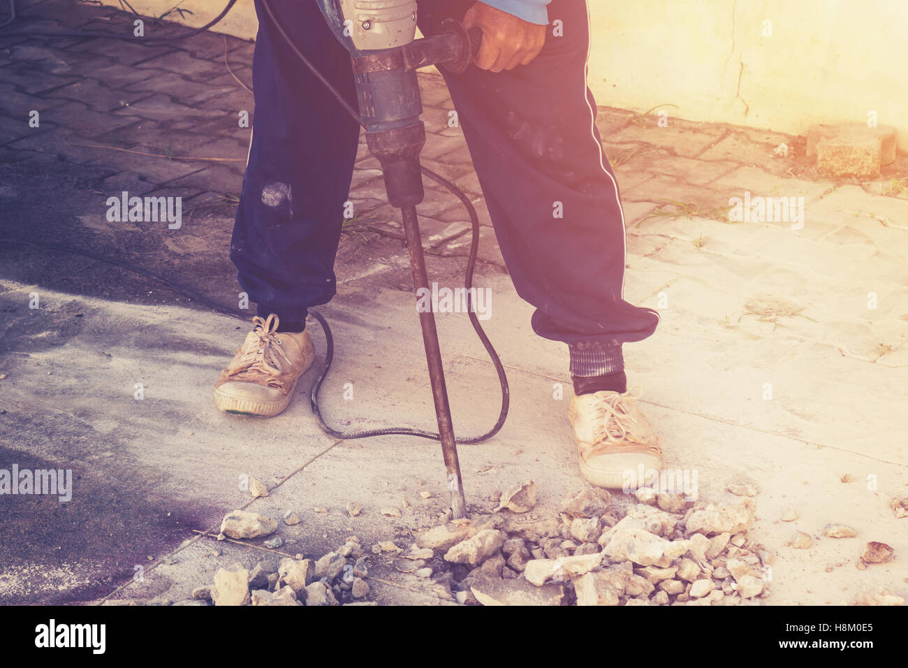 Nahaufnahme der Arbeitskraft Mann Maurer Bohren Zement Betonboden mit Maschine Stockfoto