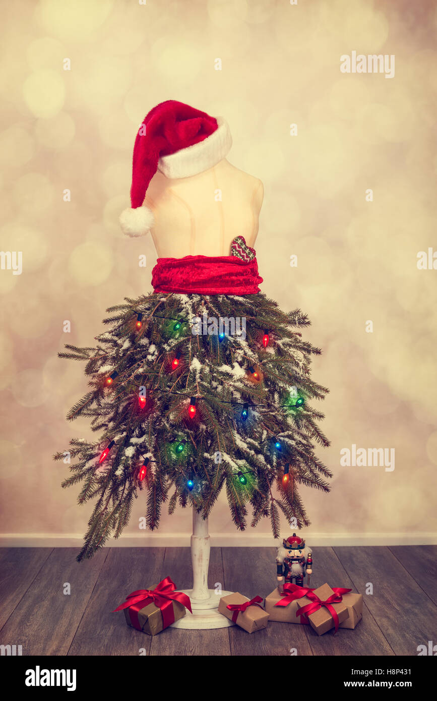 Mannequin gekleidet für eine festliche Weihnachten mit Tannenzweigen und Weihnachtsmütze Stockfoto