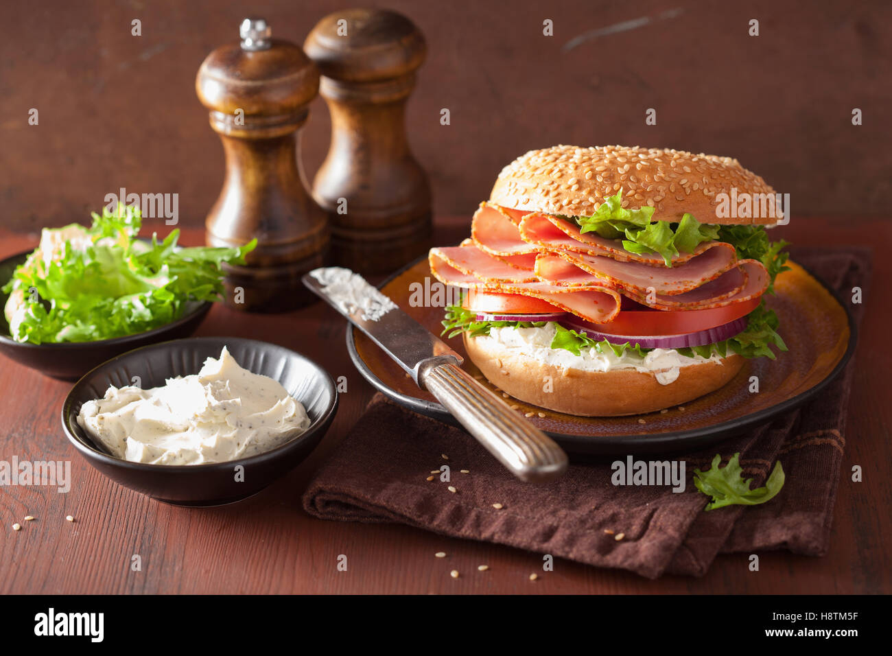 Schinkensandwich auf Bagel mit Frischkäse-Tomaten-Zwiebel Stockfoto