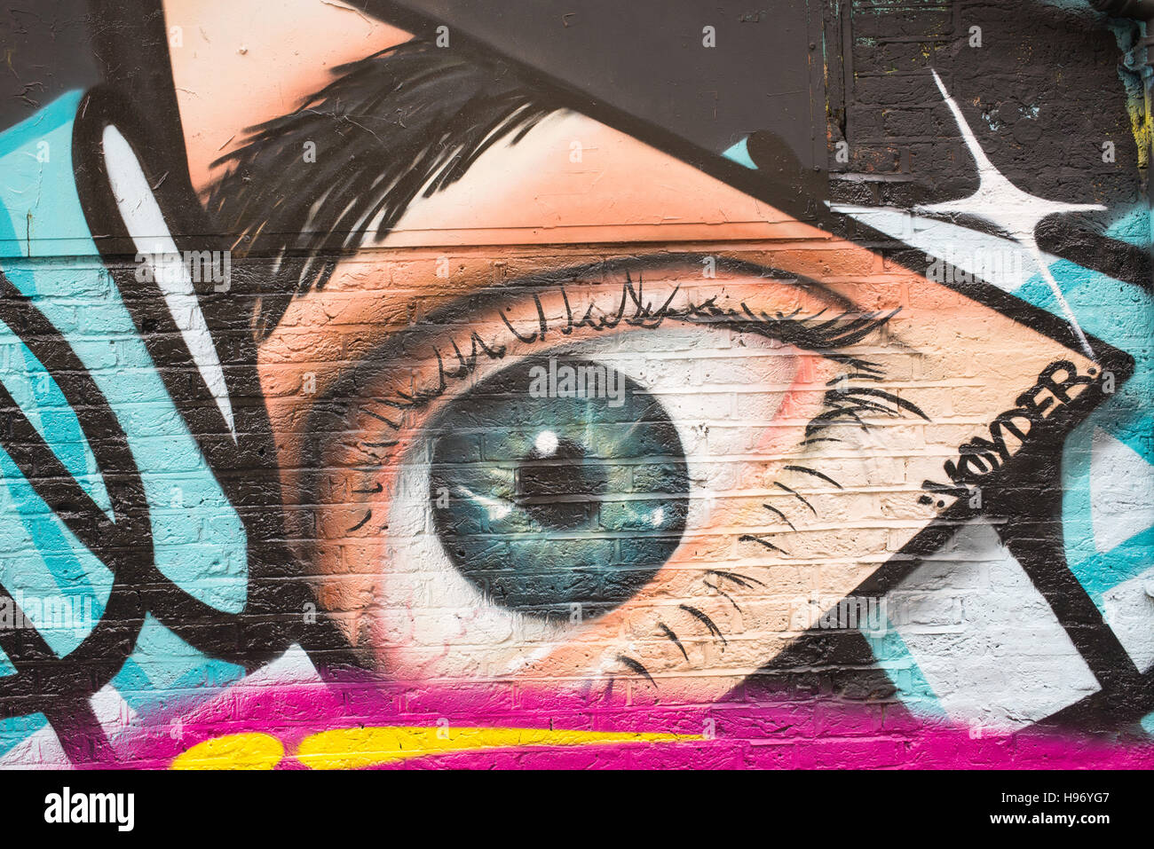 Graffiti an der Wand mit dem großen blauen offenes Auge anschauen Stockfoto