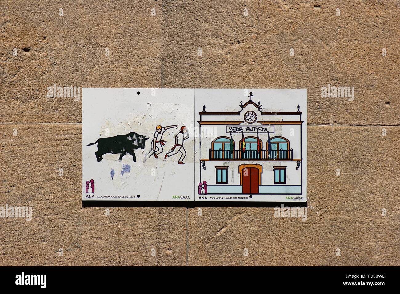 Fliesen auf einer Außenwand zeigen den jährlichen Lauf der Bullen und das historische Rathaus in Pamplona, Spanien. Stockfoto