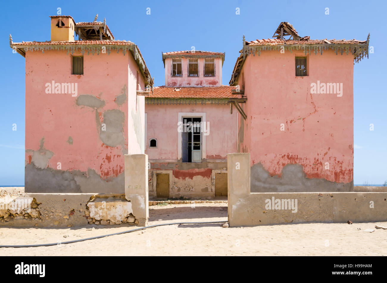 Große rosa ruiniert Herrenhaus aus der portugiesischen Kolonialzeit in kleinen Küsten-Dorf Angolas Namib-Wüste. Stockfoto