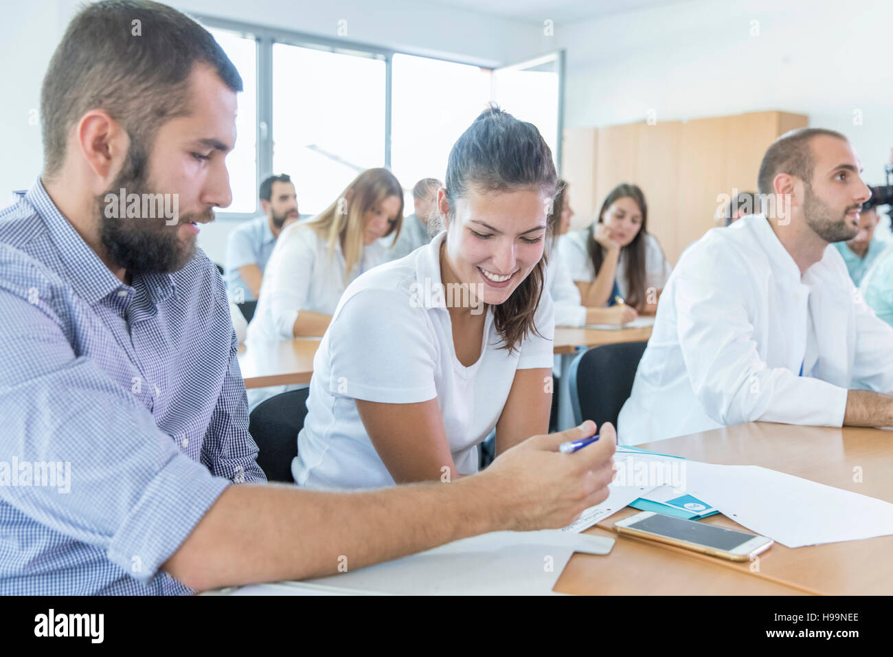 Studenten in der Ausbildung Klasse Smartphone betrachten Stockfoto