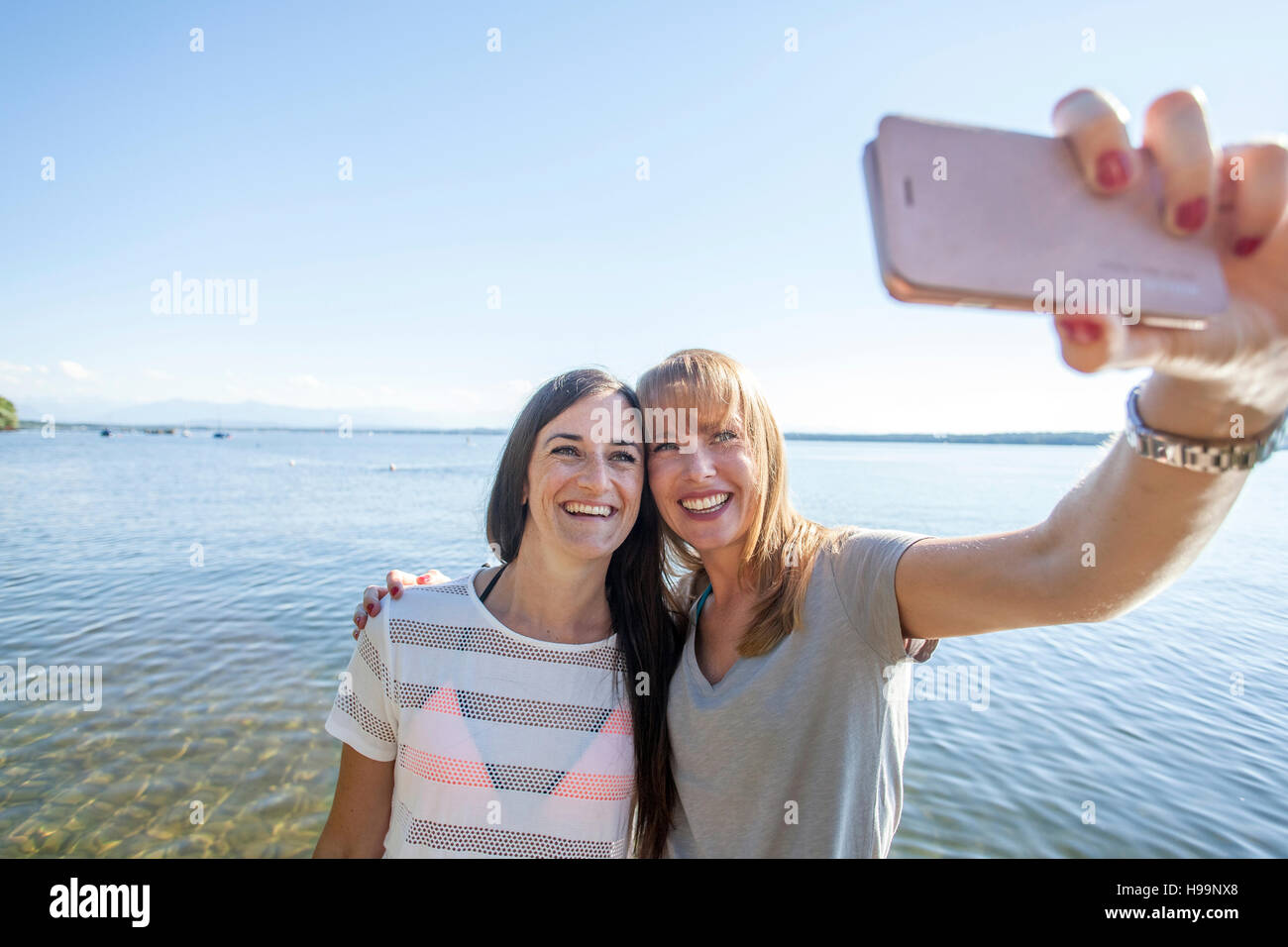 Zwei junge Frauen, die die Selfie See Stockfoto
