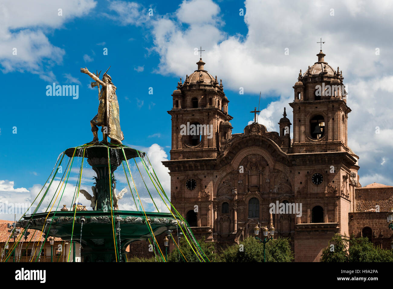 Blick auf die Statue des Kaisers der Inka mit der Kirche Od Compania de Jesus auf der Rückseite in Cuzco, Peru Stockfoto