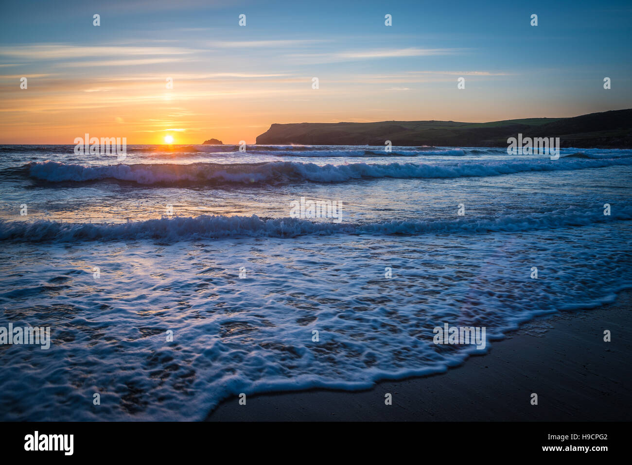 Plätschernden Wellen bei Sonnenuntergang am Polzeath Strand, Cornwall, UK Stockfoto