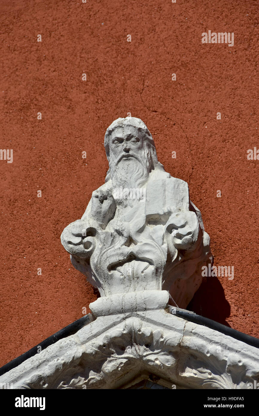 Kleine Heilige Statue Hand wuchs in Segen, auf einer roten Wand in Venedig Stockfoto