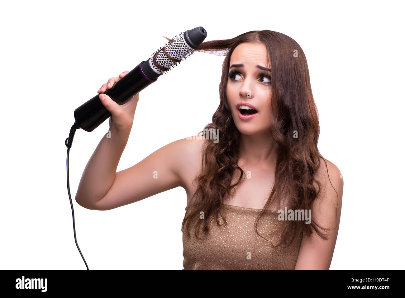 Junge schöne Frau mit Fön isoliert auf weiss Stockfoto