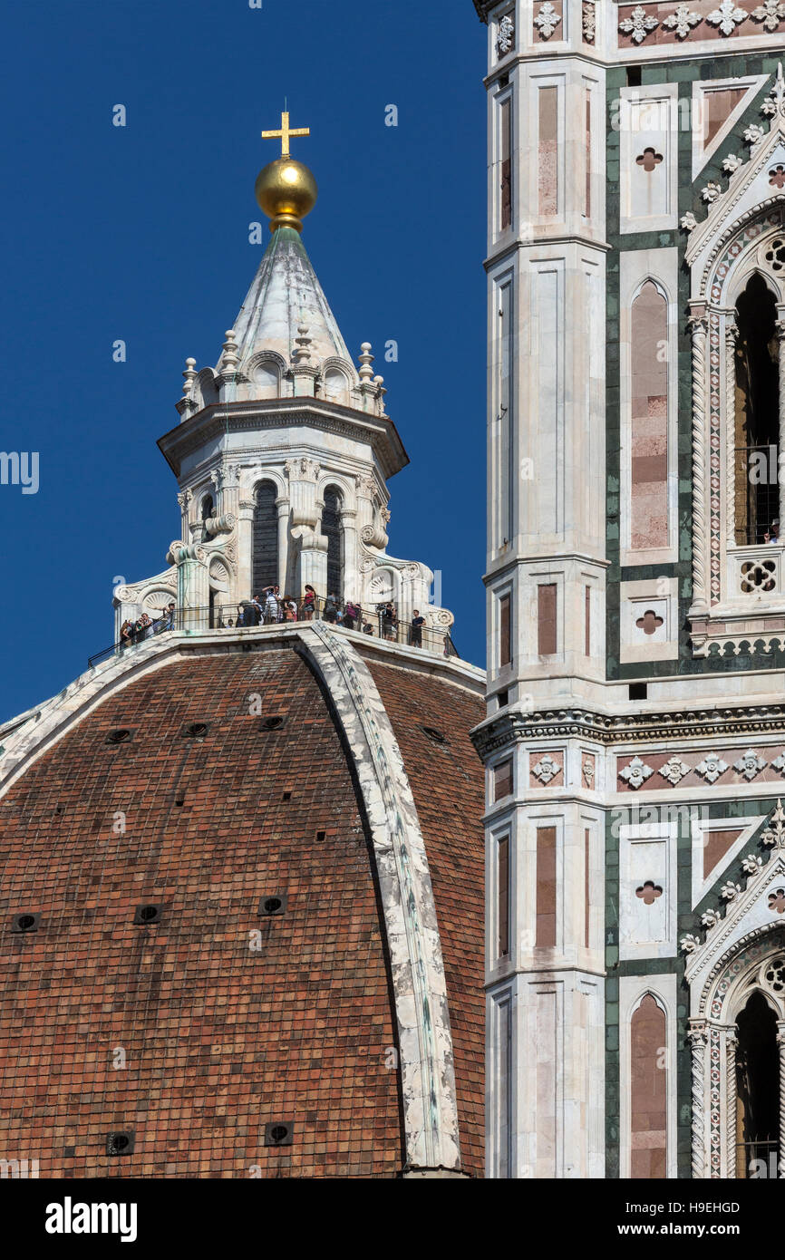 Touristen auf der Kuppel des Doms neben Giottos Campanile in Florenz in der Region Toskana in Italien. Stockfoto