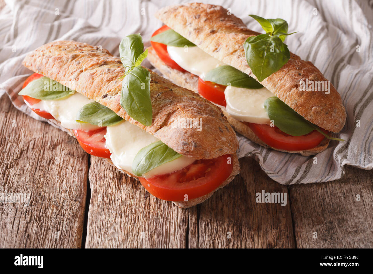 Italienische Sandwiches mit frischen Tomaten, Mozzarella-Käse und Basilikum Nahaufnahme auf dem Tisch. horizontale Stockfoto