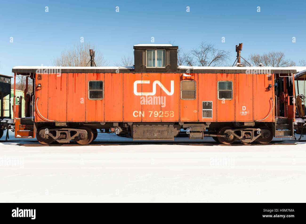 Alte Farbe orange Canadian National Railway Caboose geparkt auf dem Hof im Winter Stockfoto