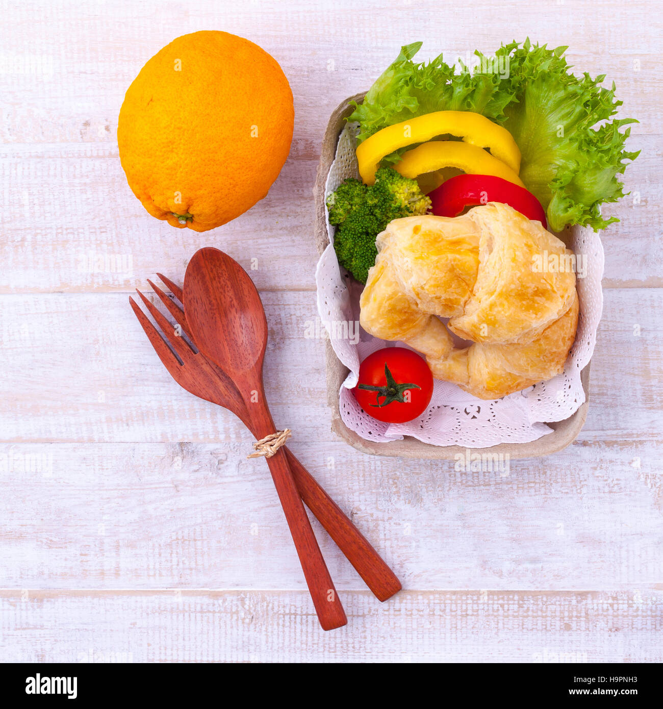 Saubere Lebensmittel Frühstück Croissant und Salat auf Holztisch. Stockfoto