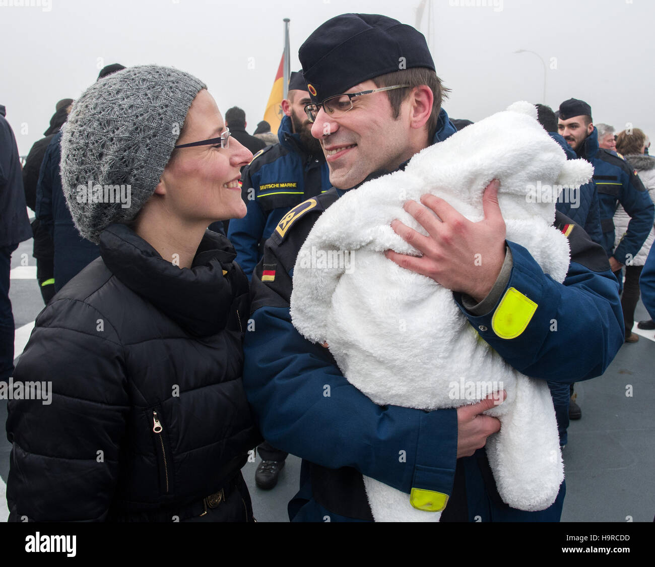 Wilhelmshaven, Deutschland. 25. November 2016. Allgemeine Petty Officer Timo Nippe wird von seiner Frau Jill Nippe und Tochter Clara nach der Ankunft der Fregatte "Augsburg" bei der marine Station Wilhelmshaven, Deutschland, 25. November 2016 begrüßt. Das deutsche Militär Fregatte kehrte von einer drei-Monats-Mission gegen die Terrororganisation ISIL vom Mittelmeer entfernt. Foto: Ingo Wagner/Dpa/Alamy Live News Stockfoto