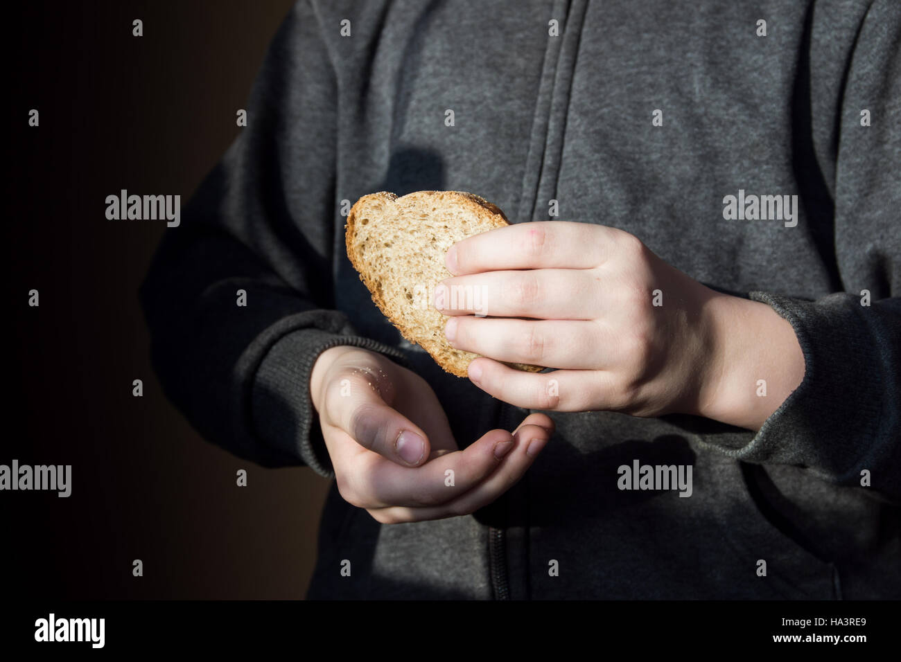 Stück Brot in die Hände von Kindern. Hunger und helfende Konzept. Stockfoto