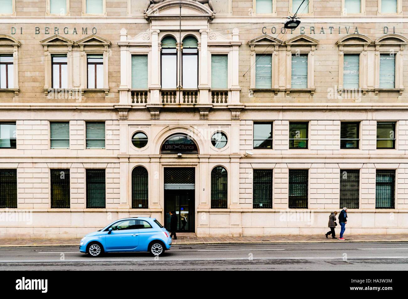 Fiat 500 vor der ehemaligen Banca populäre Di Bergamo Genossenschaft Di Credito Gebäude (Popular Bank von Bergamo, Kreditgenossenschaft), UBI Banca geparkt. Stockfoto